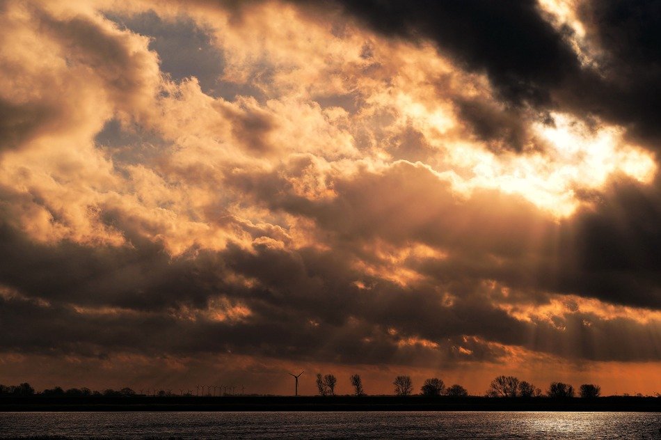 romantic sunset in the clouds above the water