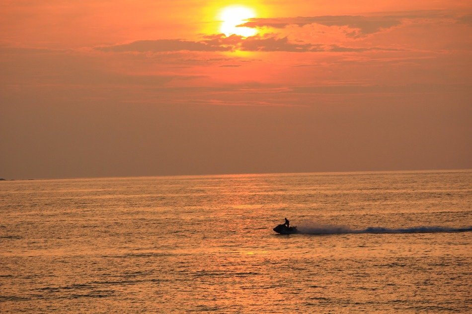 boat at sea during sunset