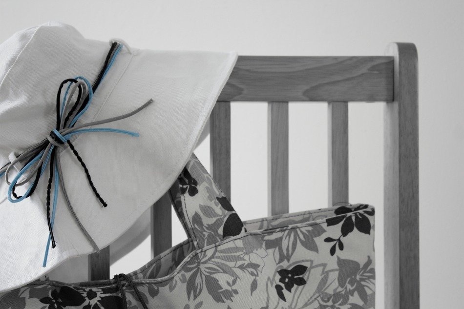 black and white photo of the chair with a bag and panama
