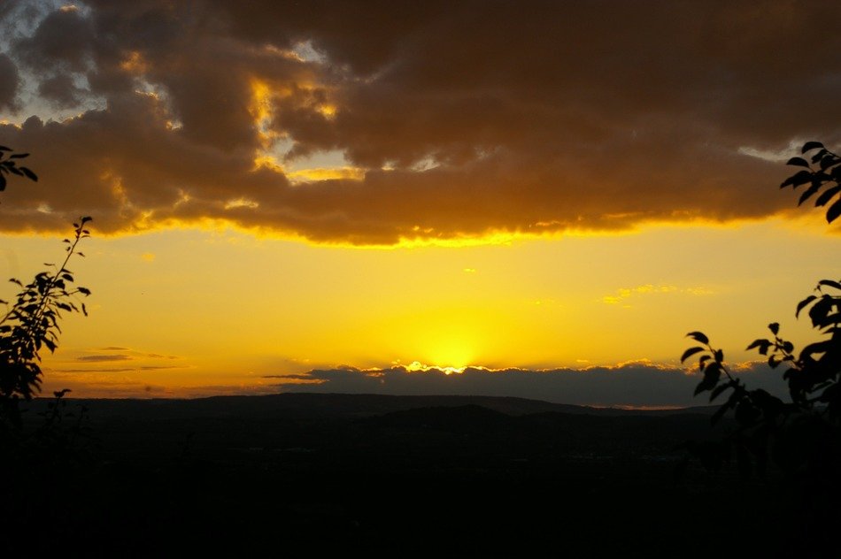 yellow clouds and bright sun on the horizon