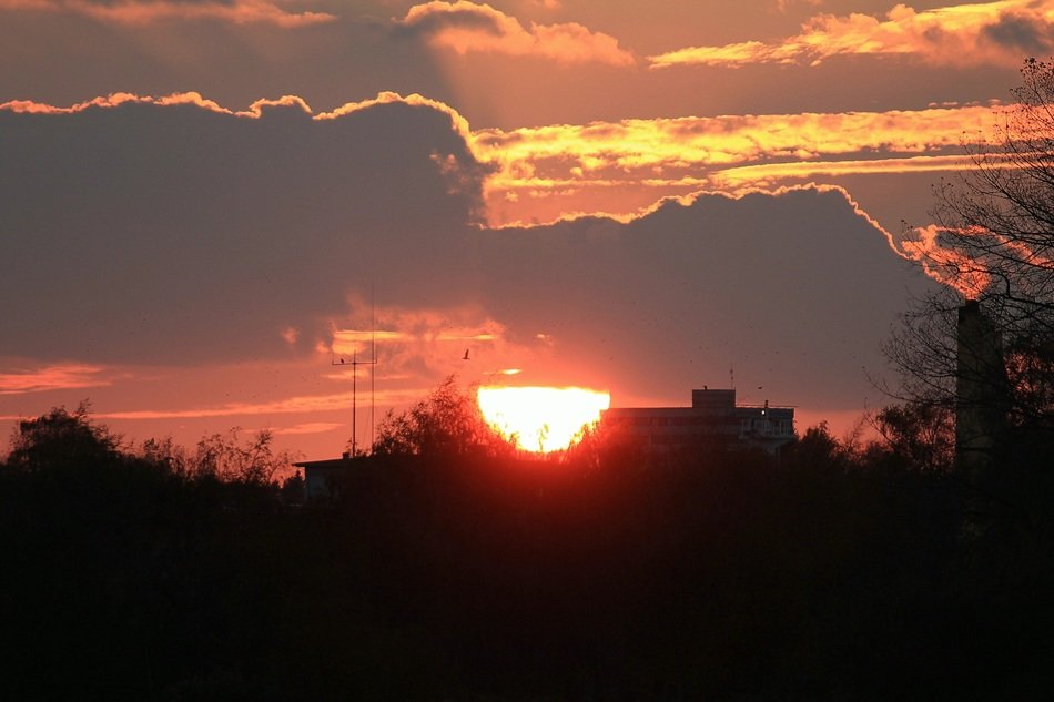 half of the evening sun in the clouds