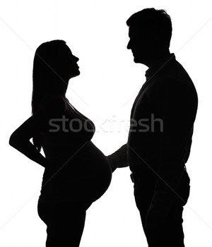 Foto Stock Silhouette Of The Pregnant Woman With Husband Isolated On