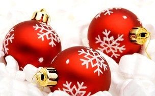 red christmas toys with drawings of snowflakes lie on the snow