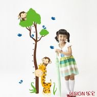 little girl on a background of a giraffe near a tree