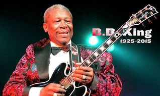 portrait of an afro american musician with a guitar in his hands