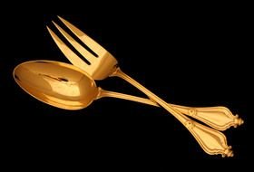 golden fork and spoon on a black background