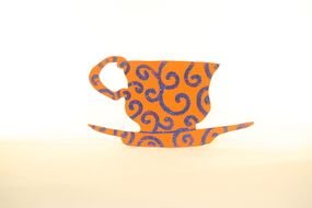 orange silhouette cups and saucer with patterns