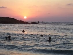 swimming sunset