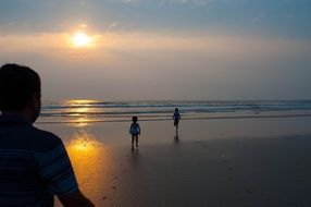 children on indian beach at sunset