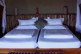 elegant snow-white bed in the hotel room