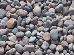 large round pebbles of pastel colors on the seashore