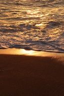 golden sand and water, beach at sunset