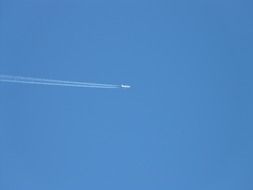 trail from a plane in the blue sky