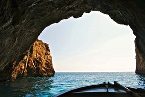 boat under a rocky arch