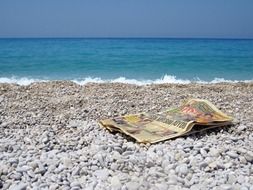 old newspaper on a pebble beach
