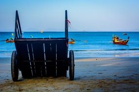 cart wheel on beach board in sea