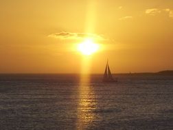 Sailboat swimming at the sunset