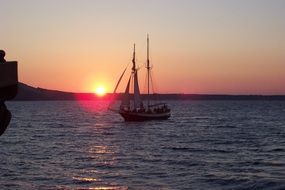 sailboat in the sea at sunset, greece, santorini