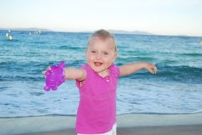 cheerful little girl on the beach