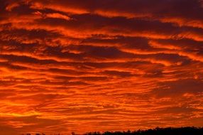 dramatic red and grey clouds in sunset sky