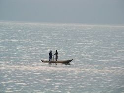 distant view of fishermen in a boat off the coast of africa