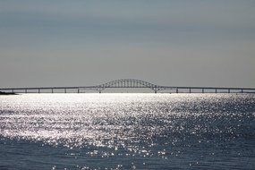 distant view of the arch bridge in the ocean on a sunny day