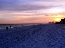 long and wide sandy beach at sunset
