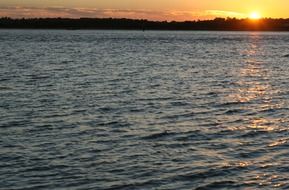 landscape of small waves on the ocean during sunset