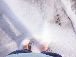 feet in ocean foam
