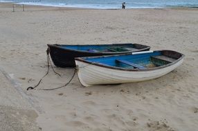 white and black boats on sea shore