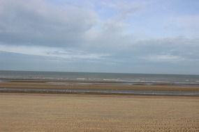 blue sky on the horizon of a sandy beach
