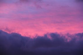 pink sky behind the clouds during sunset