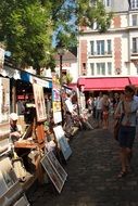 tourists and painters with artworks on street, france, paris
