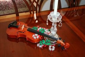 Violin in ornaments on the table