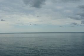 blue seascape, calm water and sky with clouds