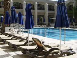 sun beds and umbrellas around the hotel pool