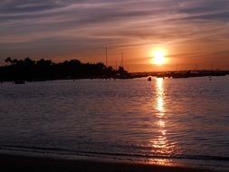 distant view of the boats at sunset