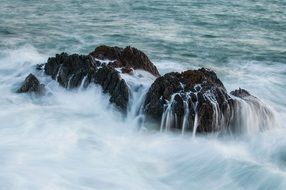 boulders in water in the ocean