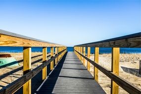 wood bridge as a path to the beach