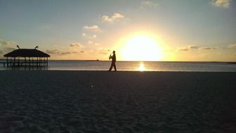 saxophonist on the beach at sunset in cuba