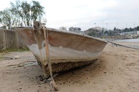 Old boat on sand beach