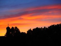 colorful magnificent sunset clouds yellow pink steeple