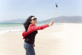 mature women taking selfie on beach