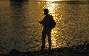photographer at the lake in the evening