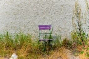 Purple chair near the wall