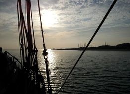 rigging of sailing boat in sea at sunset