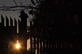 ray of sun in the cracks of the fence