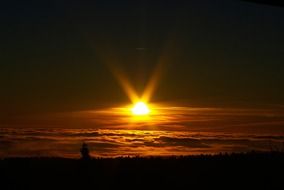 dramatic sunset above clouds