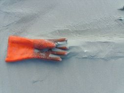 red glove on the sand