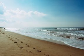 human footprints along the ocean coast